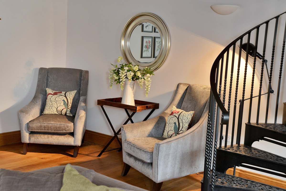 Turner House - chairs for 2 at the bottom of the spiral staircase